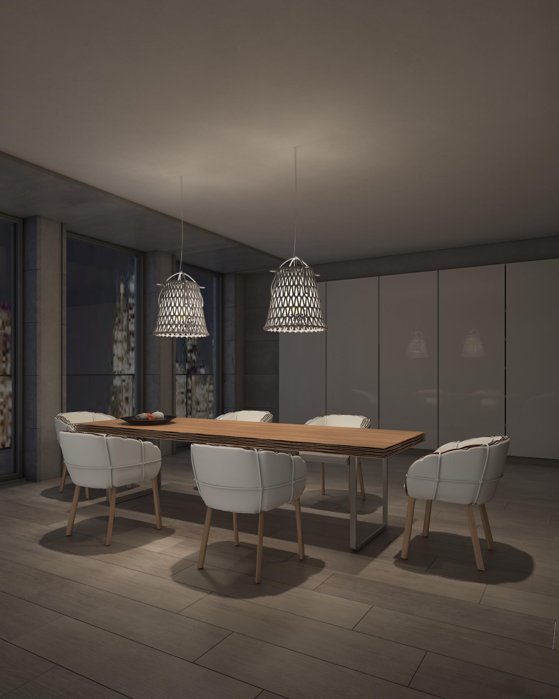 Elegant dining room featuring the Parchment seating collection by Kenneth Cobonpue, illuminated by modern pendant lights.