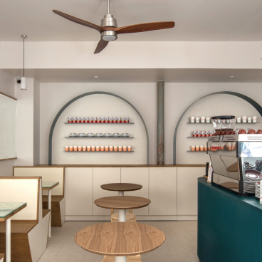 Modern Hong Kong Bing Sutt interior in Paris featuring minimalist design, wooden furniture, and a stylish coffee counter.
