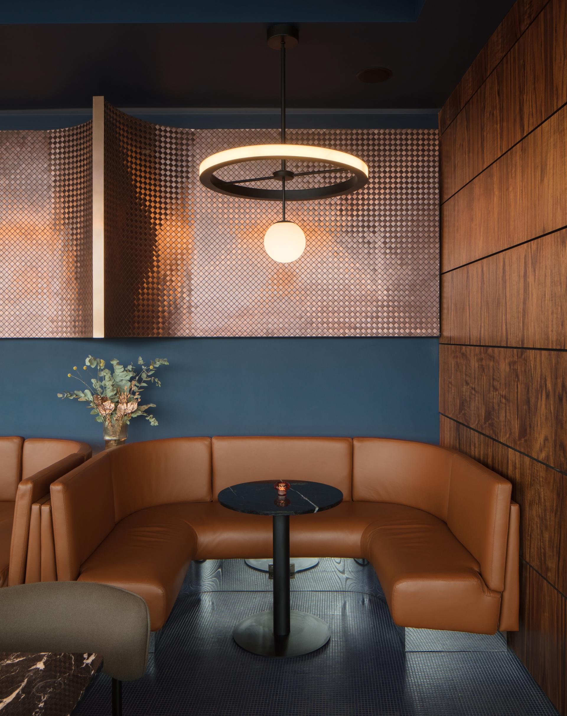 Elegant lounge area in M'Arks Sky Bar, featuring modern décor, a cozy seating arrangement, and a stylish light fixture.