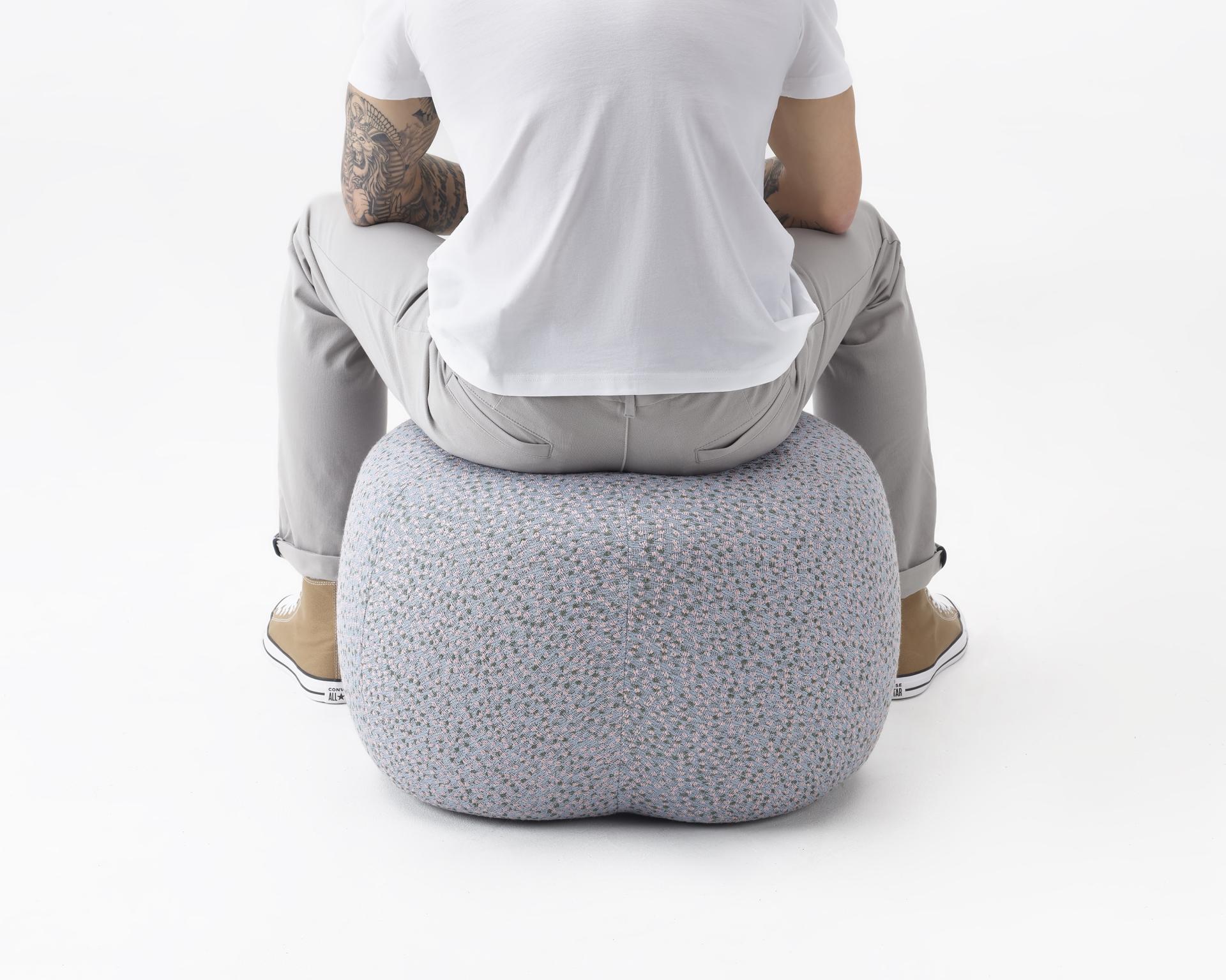 Comfortable Truffle pouf by NaughtOne, showcasing playful design, ideal for seating or resting feet.