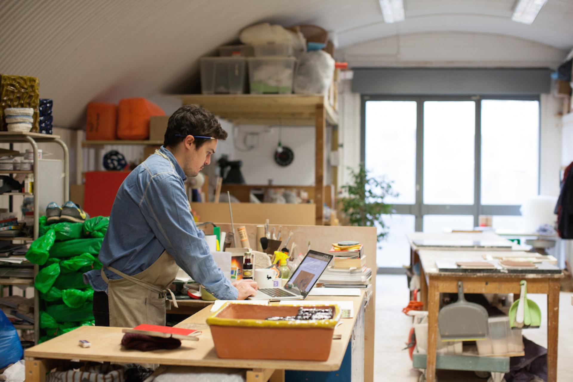 Ceramic artist Matthew Raw working in a studio, exploring clay techniques with tools and materials around him.