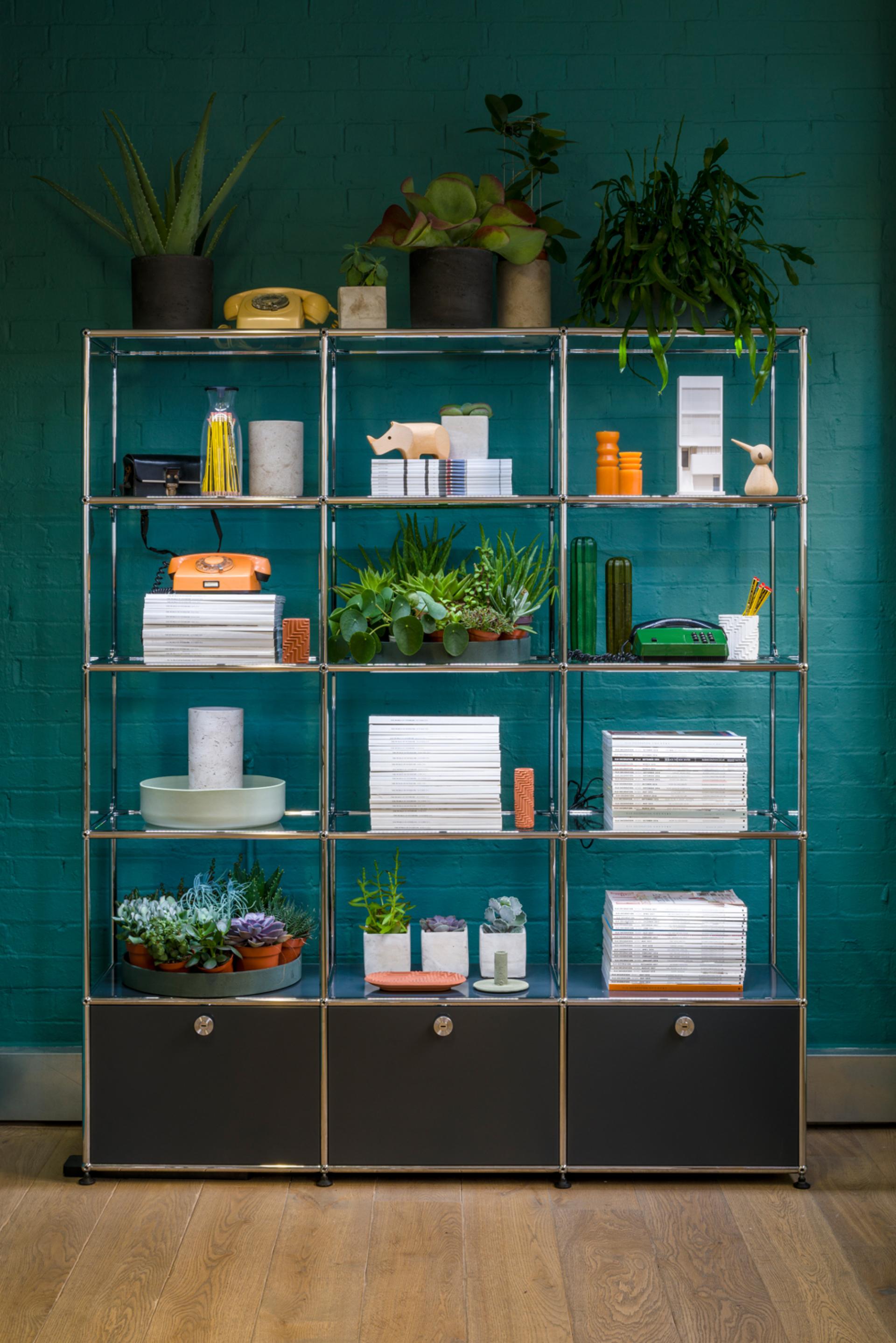Modern modular furniture display featuring plants, decor items, and accessories in USM's refreshed Clerkenwell showroom.