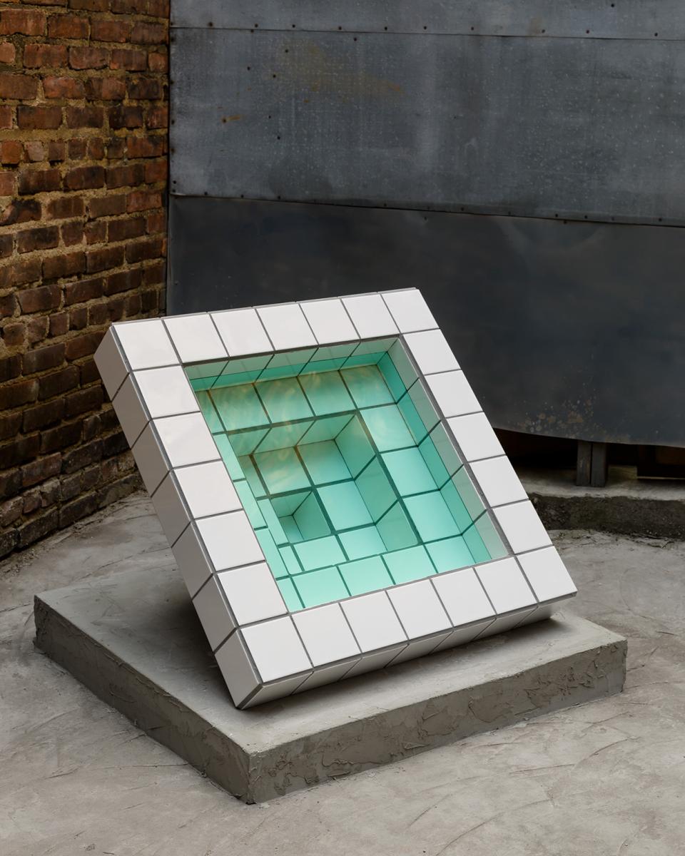 Sculptural artwork by Zac Hacmon featuring subway tiles arranged in a geometric, multi-dimensional design with a turquoise center.