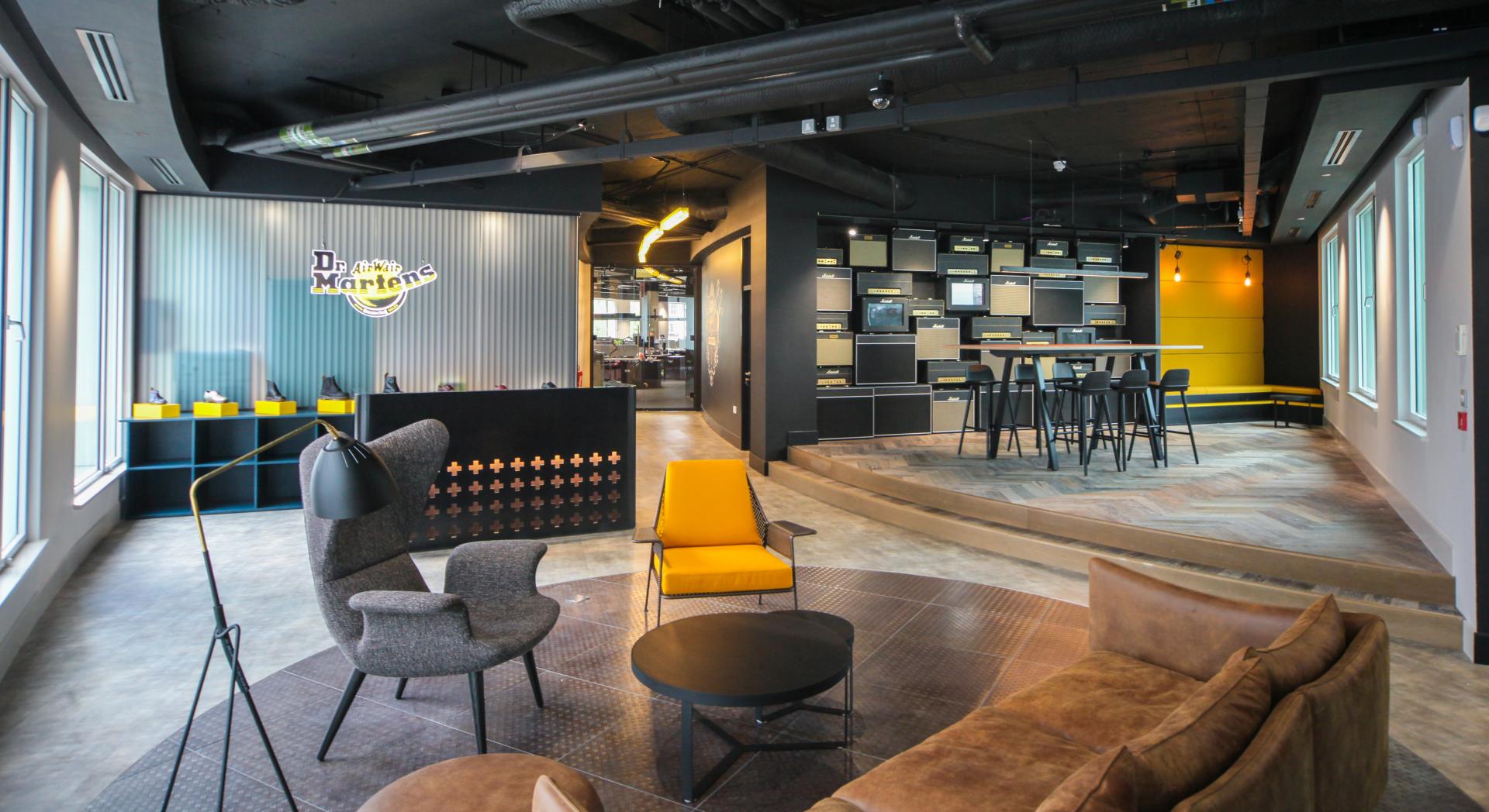 Stylish interior of SpaceInvader's workspace featuring modern furniture and Dr. Martens branding, highlighting local design.