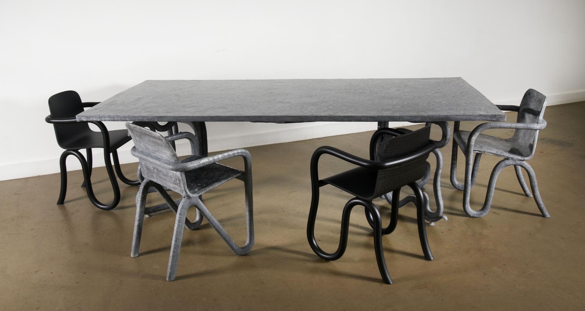 Contemporary dining table and stylish chairs inspired by lunar design showcased at Milan Design Week by Matthew Day Jackson.