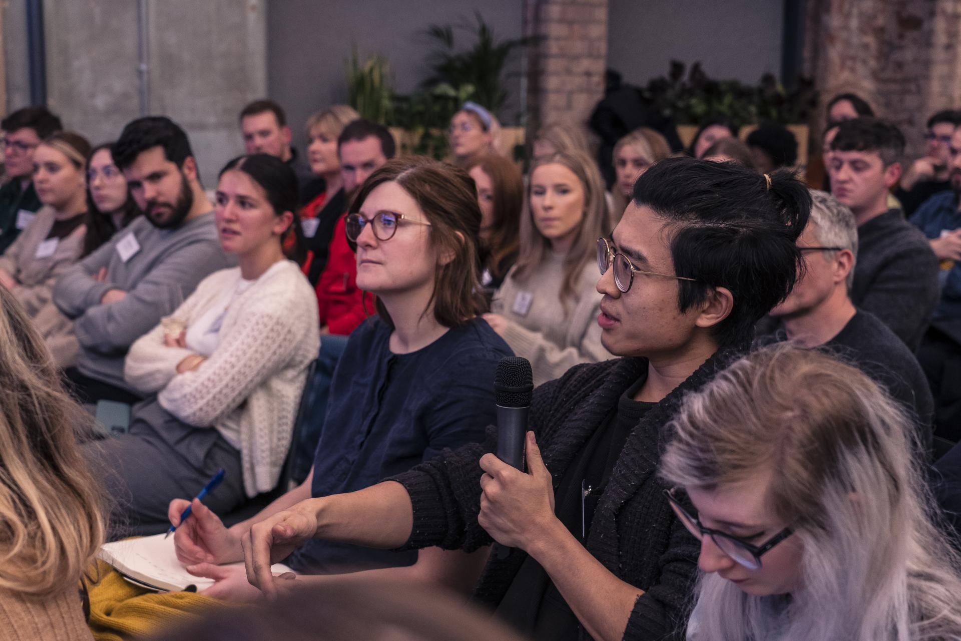 Audience engaged in discussion at the Material Source Studio seminar focused on sustainability and trust in materials.