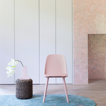 Stylish pink chair on a colorful 2LG Studio x FLOOR_STORY rug, showcasing modern home decor and design aesthetics.