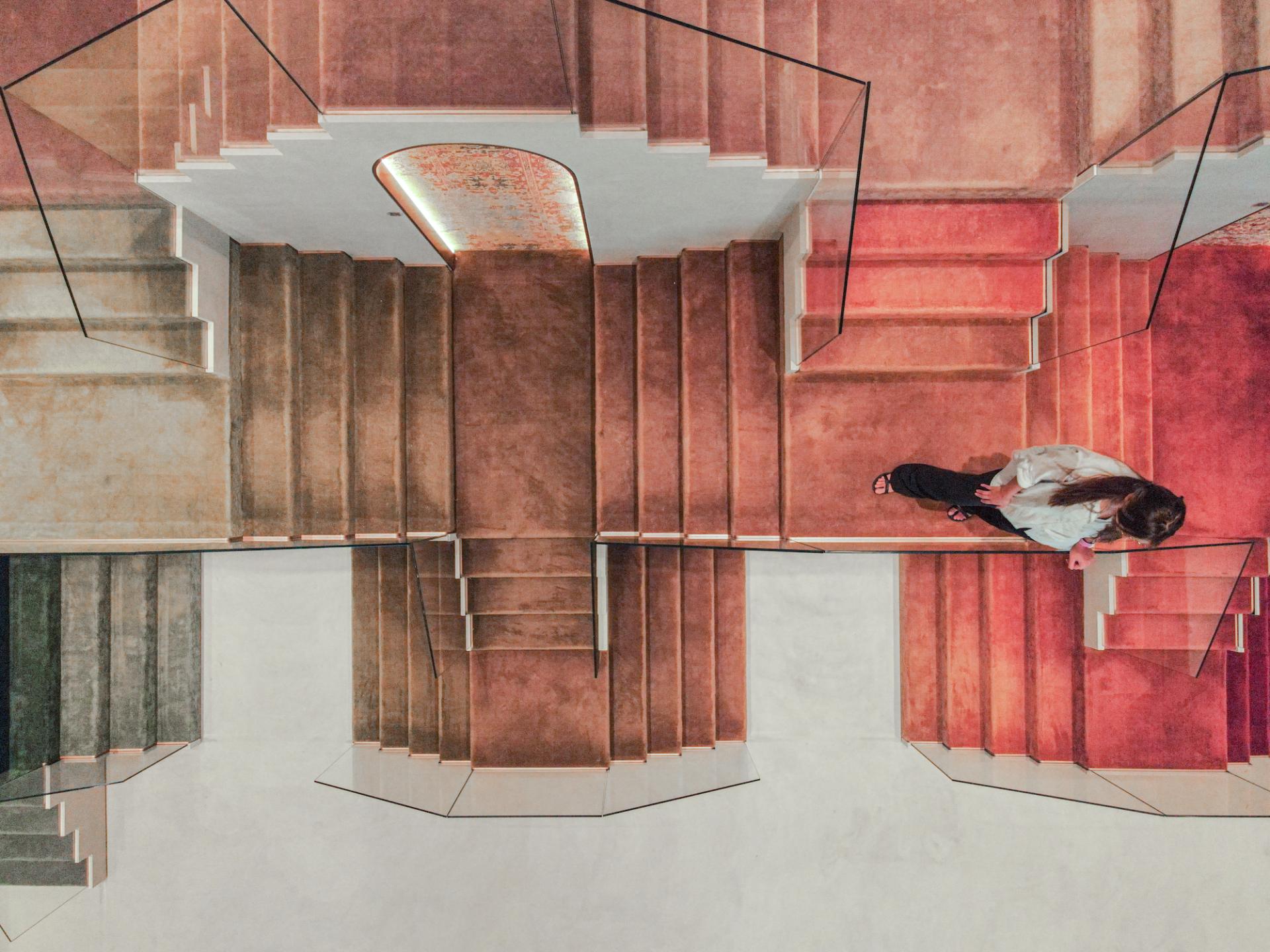 Modern staircase design inspired by Rajasthani architecture in Jaipur Rugs' Dubai showroom, featuring textured steps and a contemporary aesthetic.