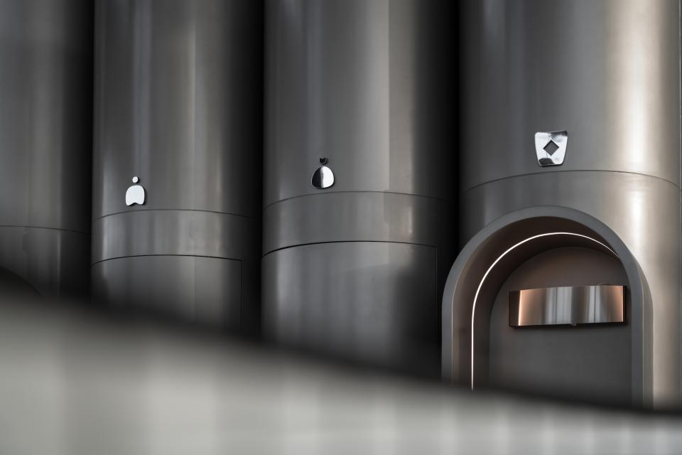 Sleek metallic columns with distinct shapes and logos, showcasing the modern design of MO bakehouse and espresso bar.