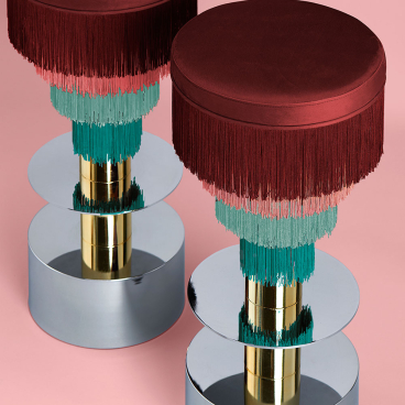 Stylish stools by Masquespacio featuring vibrant fringes, reflecting colorful design aesthetics and modern elegance for Houtique.