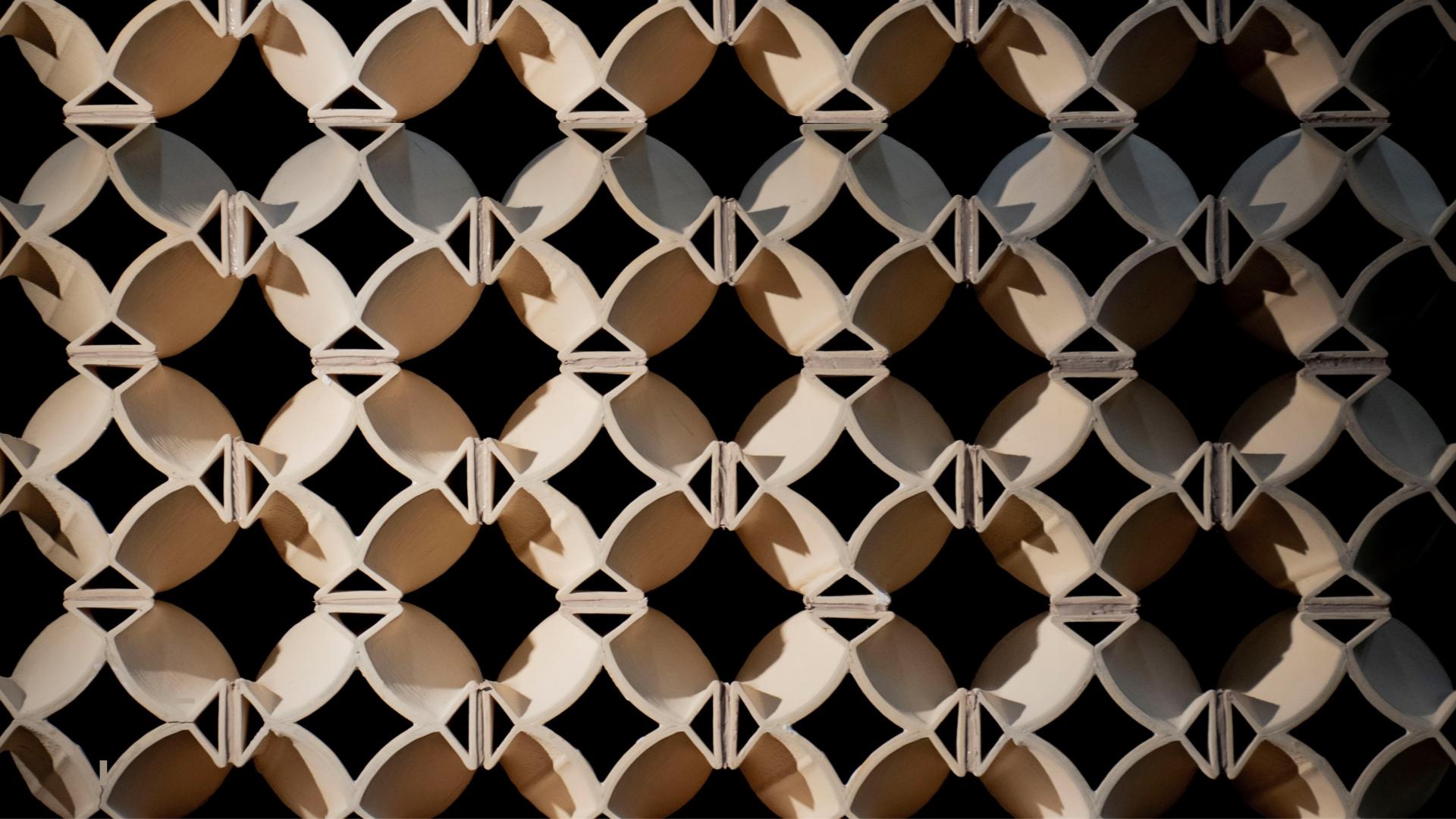 3D-printed decorative wall panel showcasing an intricate geometric pattern, highlighting innovations in construction design for 2024.
