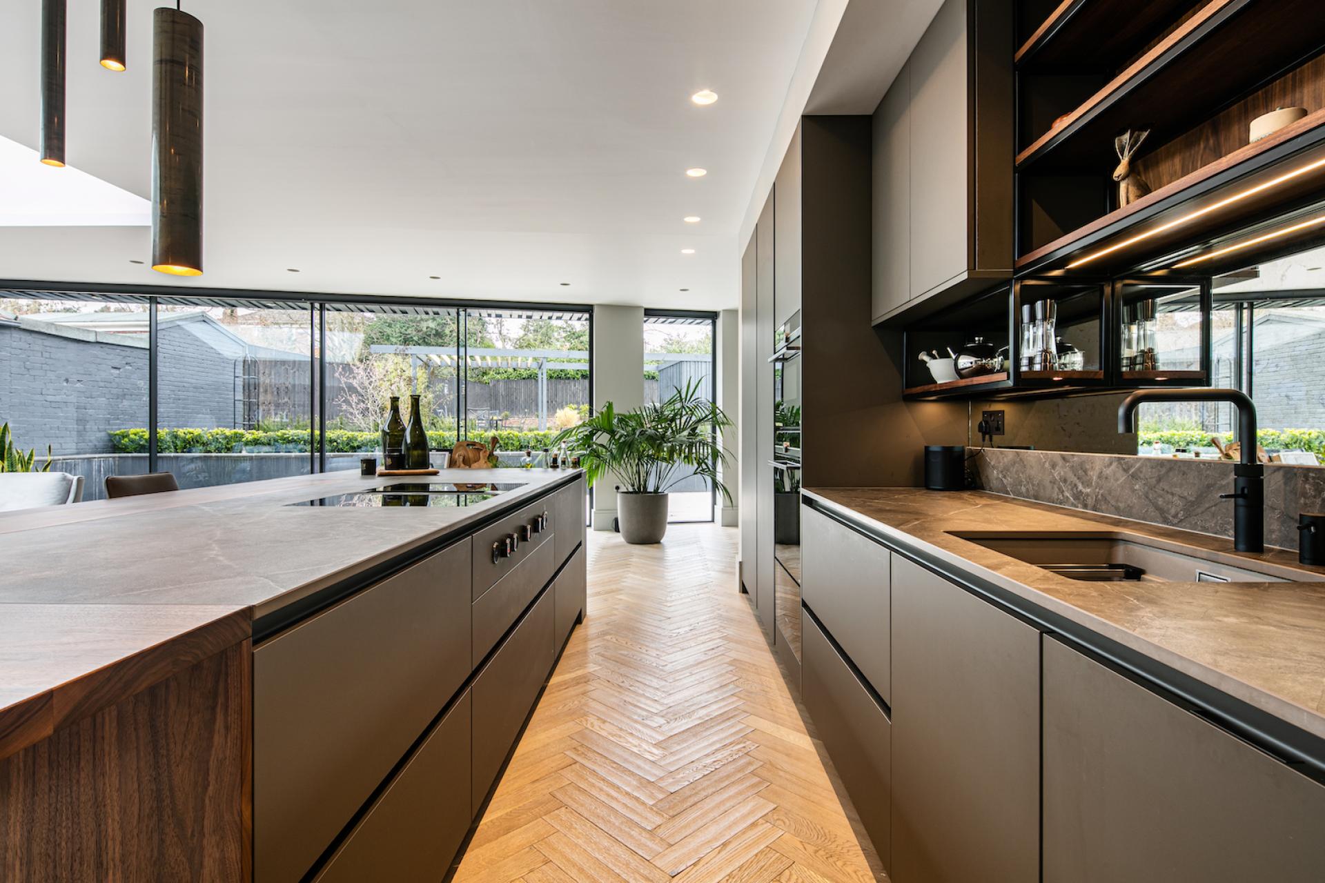 Modern kitchen showcasing multifunctional design with Dekton countertops, sleek cabinetry, and ample natural light.