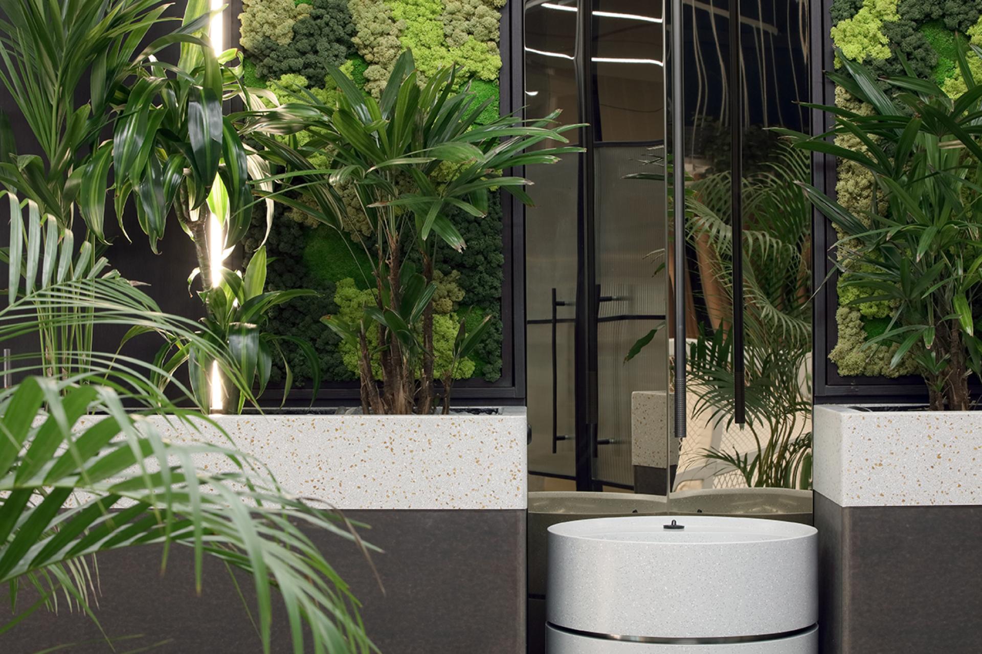 Lush indoor plants and a modern water feature create a calming atmosphere in Eden, New Bailey's social hub.