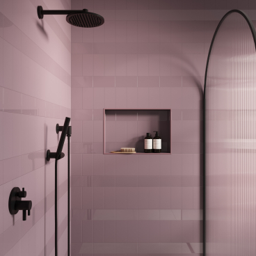 Chic bathroom featuring Parkside’s Matrix collection in soft pink tiles with black accents and a stylish shower.