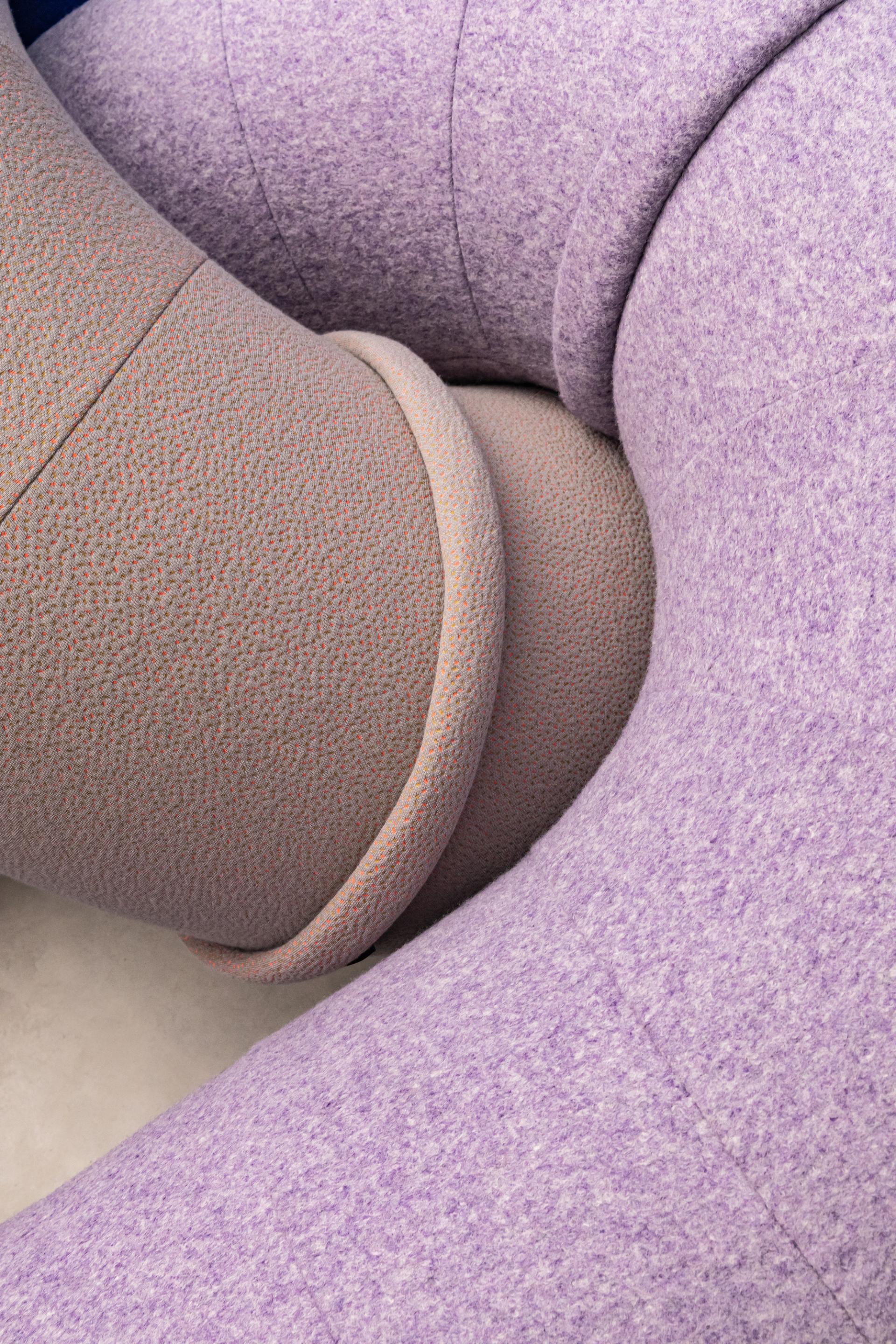 Textured, circular furniture in soft purple and beige tones, highlighting modern design and color trends from DDW 2023.