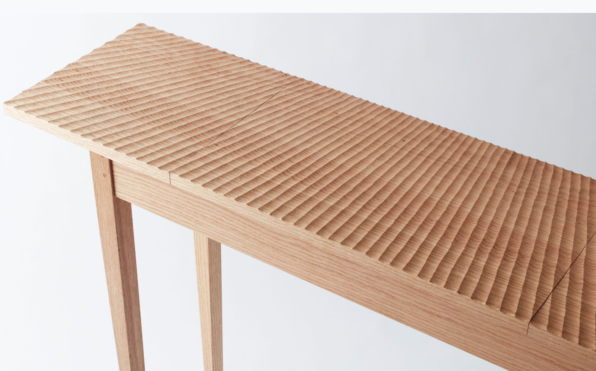 Sustainable 'Useful Table' crafted by students features a textured wooden surface and minimalist design, showcasing craftsmanship at East London’s Building Crafts College.