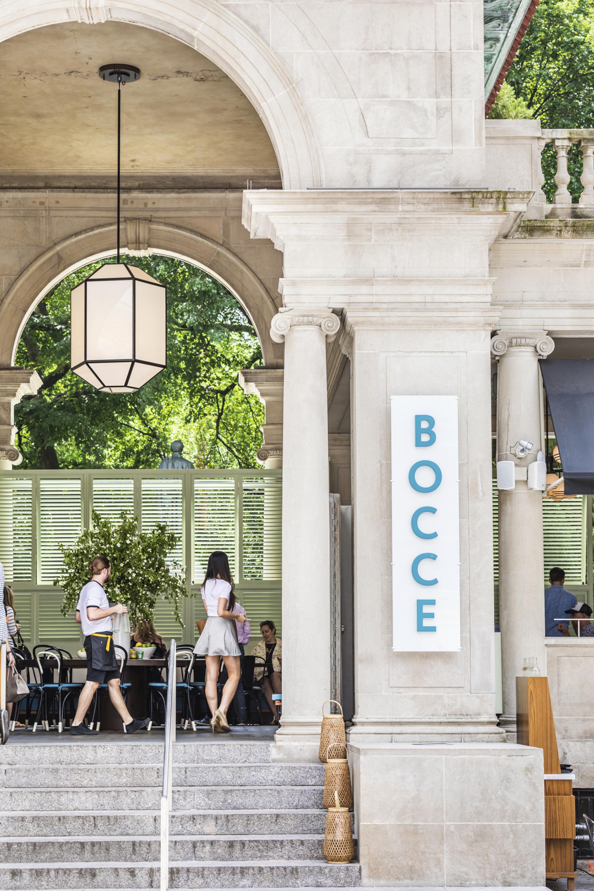 Bocce restaurant entrance in Union Square, showcasing modern design with people enjoying the vibrant atmosphere.