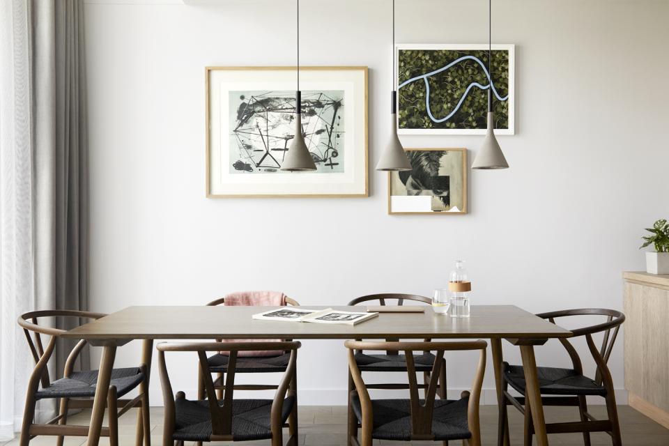 Stylish dining area at PURO Kraków Kazimierz featuring art, modern lighting, and elegant furnishings designed by Conran+Partners.