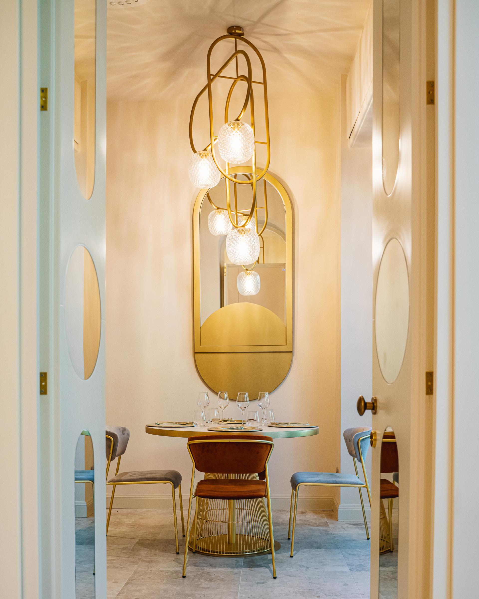 Elegant dining area in Linfa Milano featuring S•CAB furnishings, a modern light fixture, and stylish table settings.