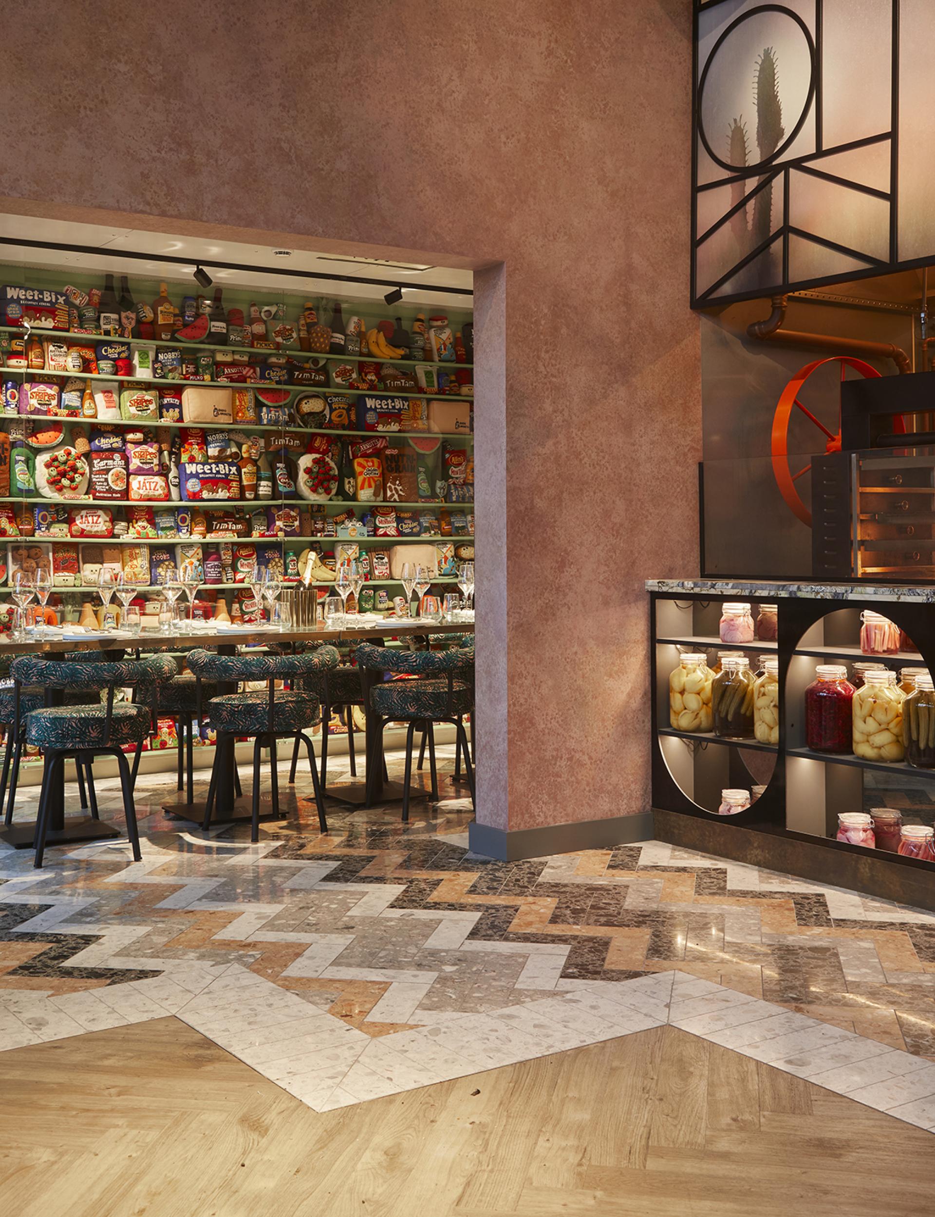 Vibrant interior of Bondi Green showcasing retro snacks, stylish bar stools, and unique marbled flooring inspired by Miami decor.