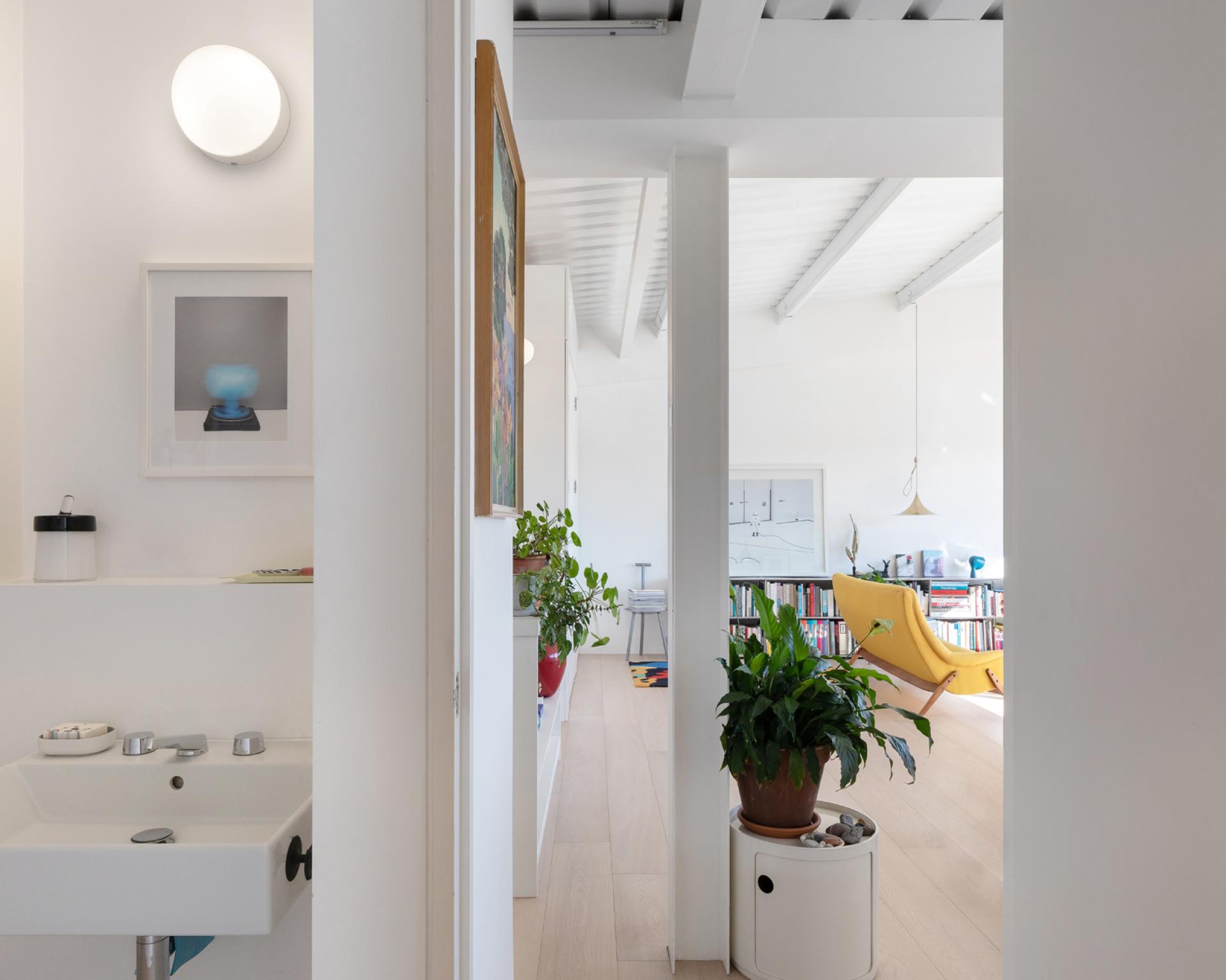 Stylish studio flat interior with modern decor, bright lighting, and artistic elements in a historic building.