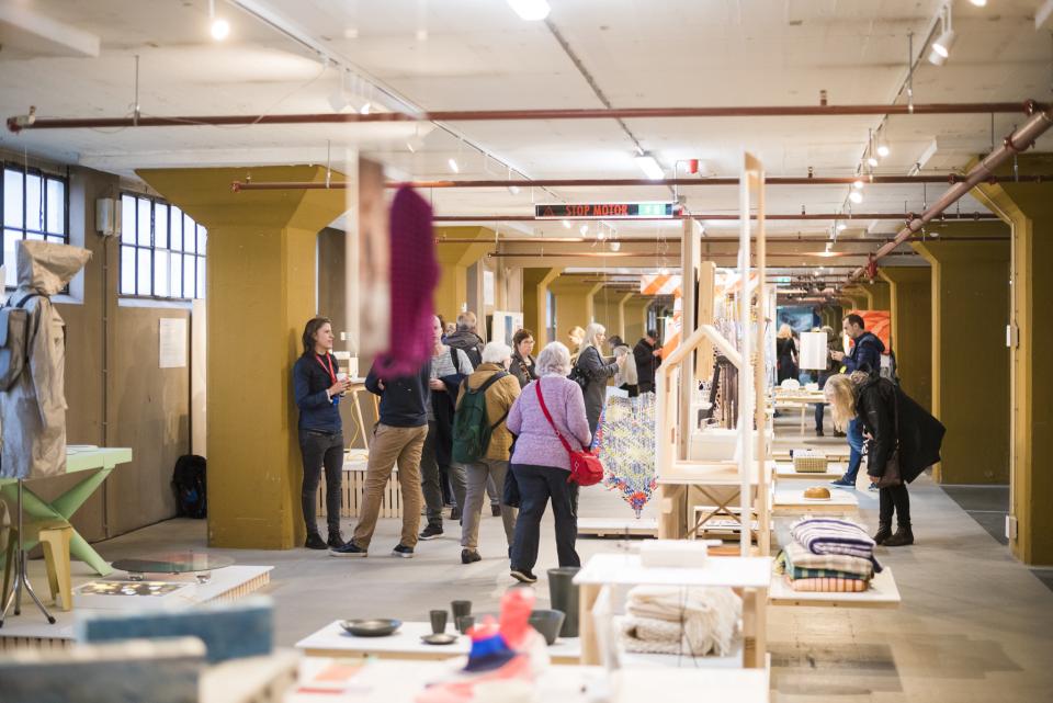 Visitors explore innovative designs at the Dutch Design Week exhibition, showcasing creativity and sustainability in the design industry.