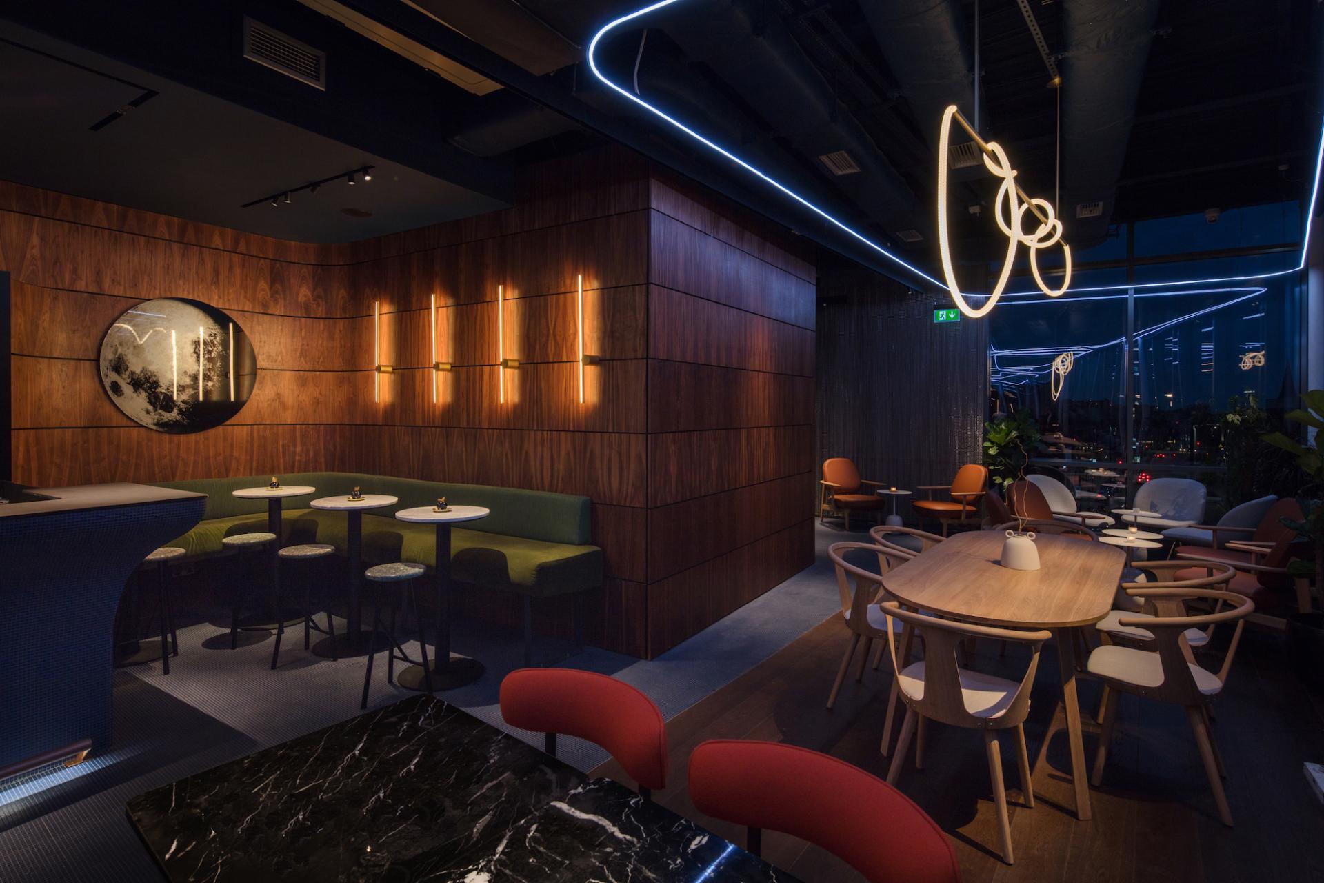Modern interior of M'Arks Sky Bar in London featuring stylish furniture and ambient lighting, perfect for relaxation and socializing.