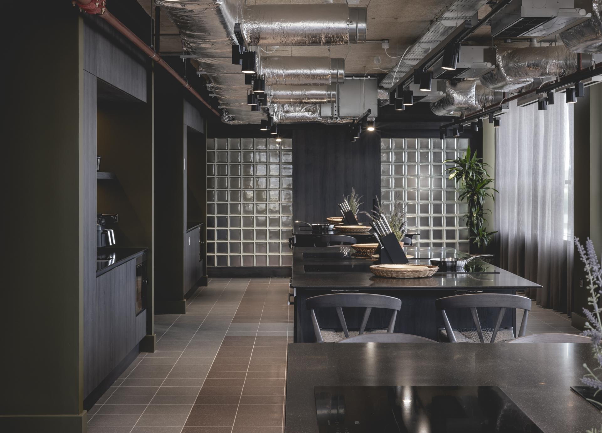Modern commercial kitchen interior featuring sleek design, contrasting colors, and elements promoting harmonious architecture in Liverpool.