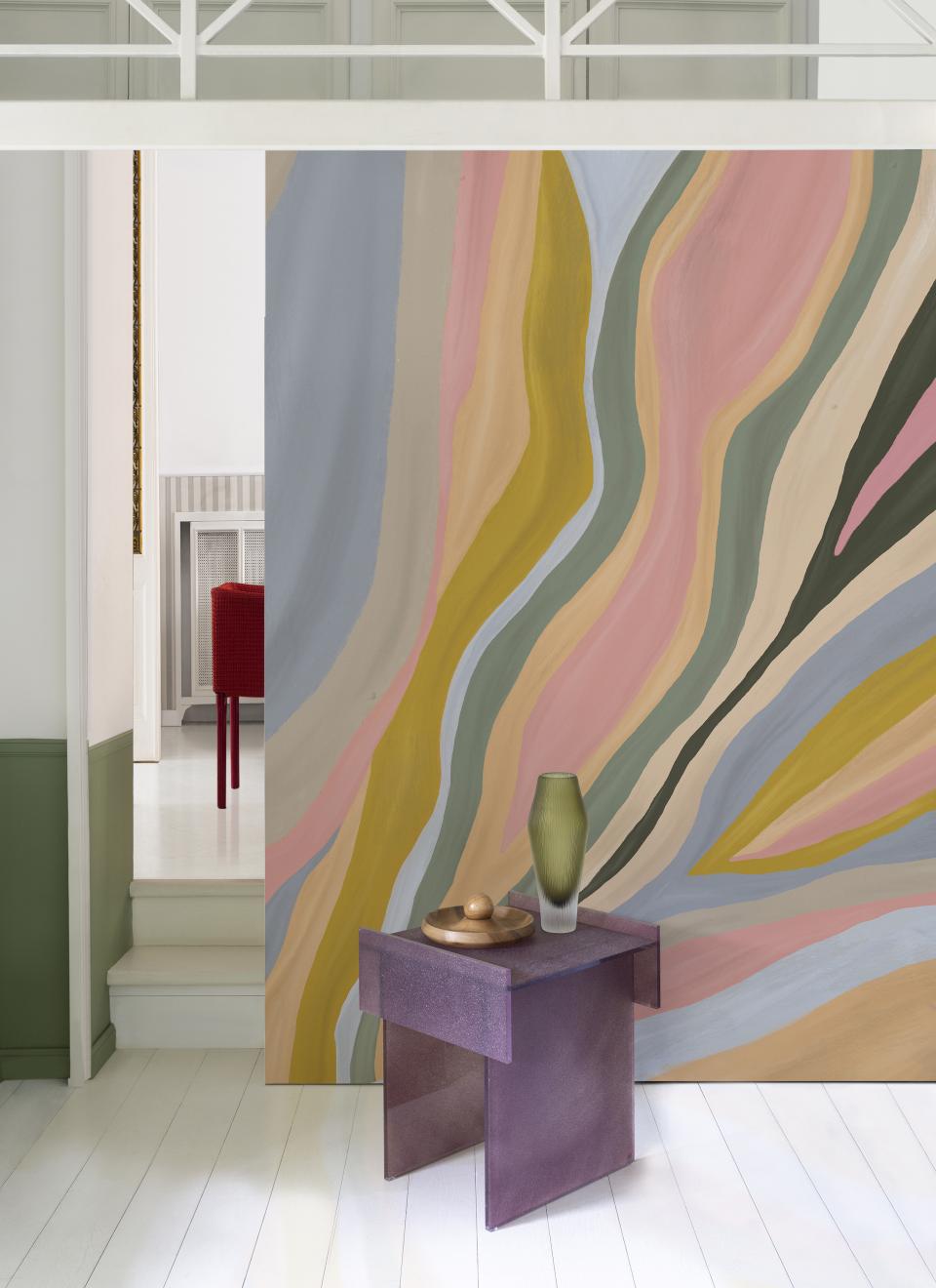 Contemporary wallpaper featuring bold, colorful swirls enhances a modern interior space with stylish décor elements.
