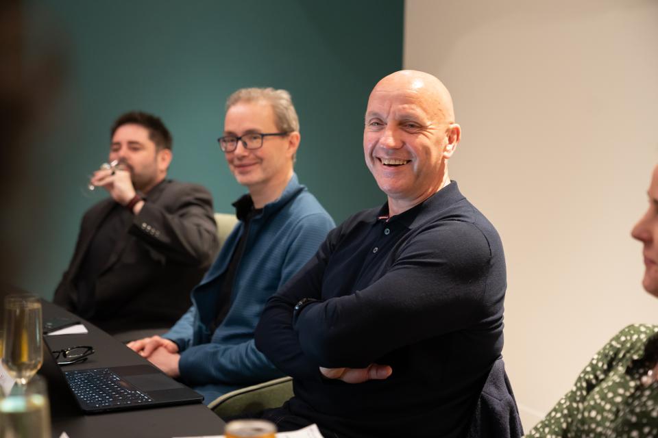 Participants engaging in discussion during a technology seminar focused on advancements in the workplace.