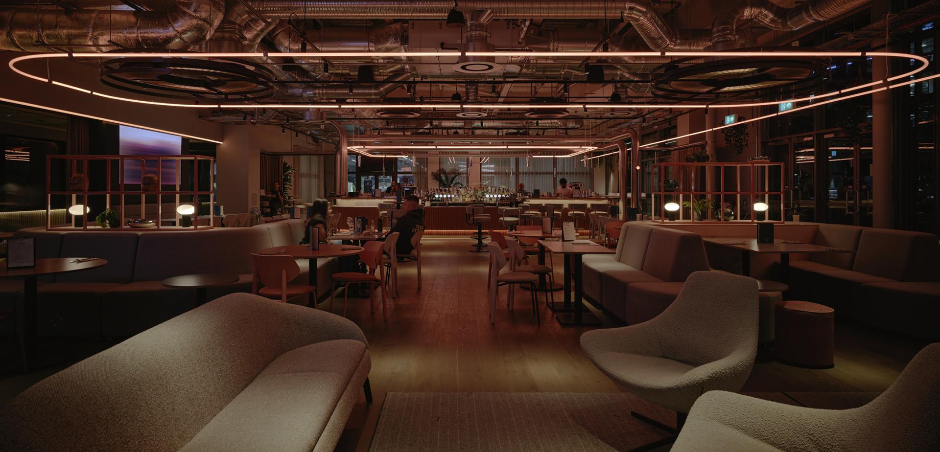 Modern interior design of a café in Manchester, featuring stylish seating and ambient lighting, highlighting creative architecture.