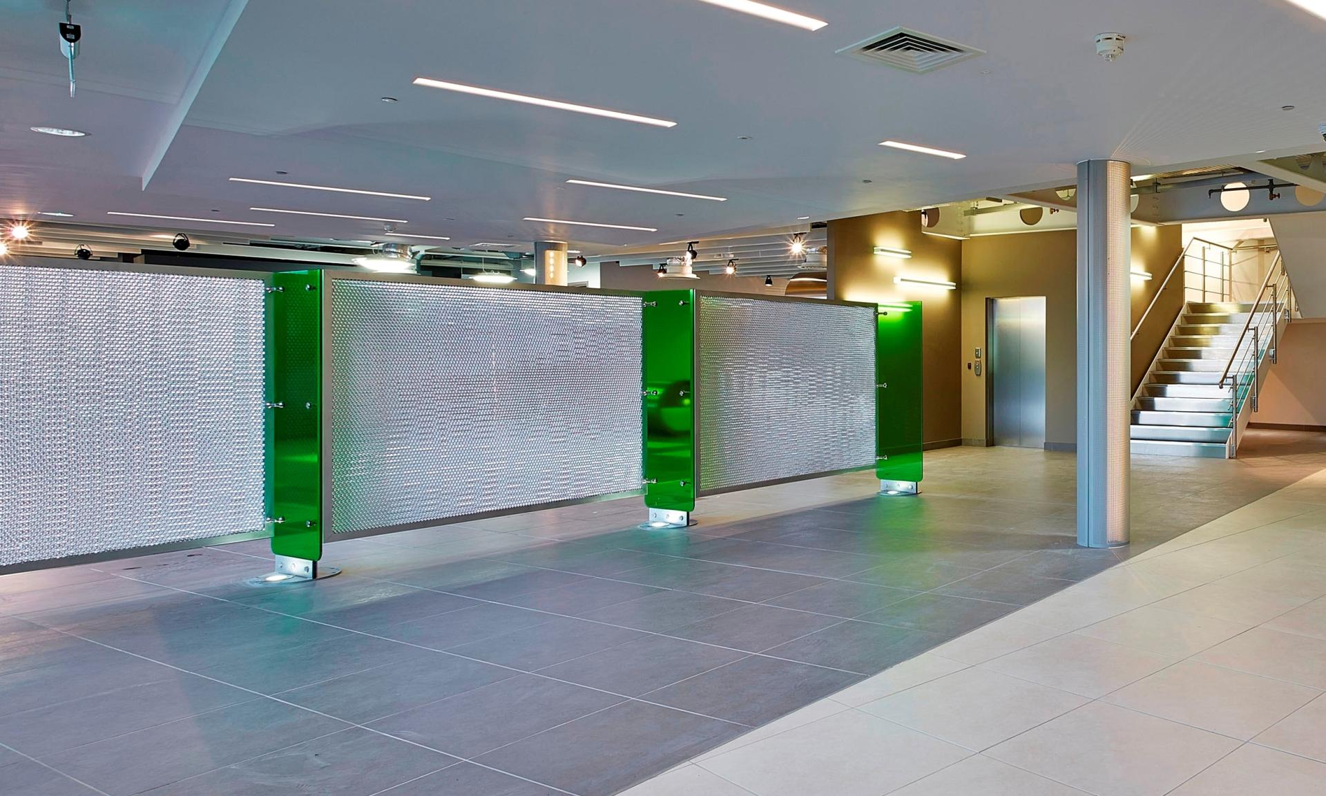 Decorative aluminium composite panels create a modern partition in a stylish interior space, showcasing Mykon's innovative surface solutions.