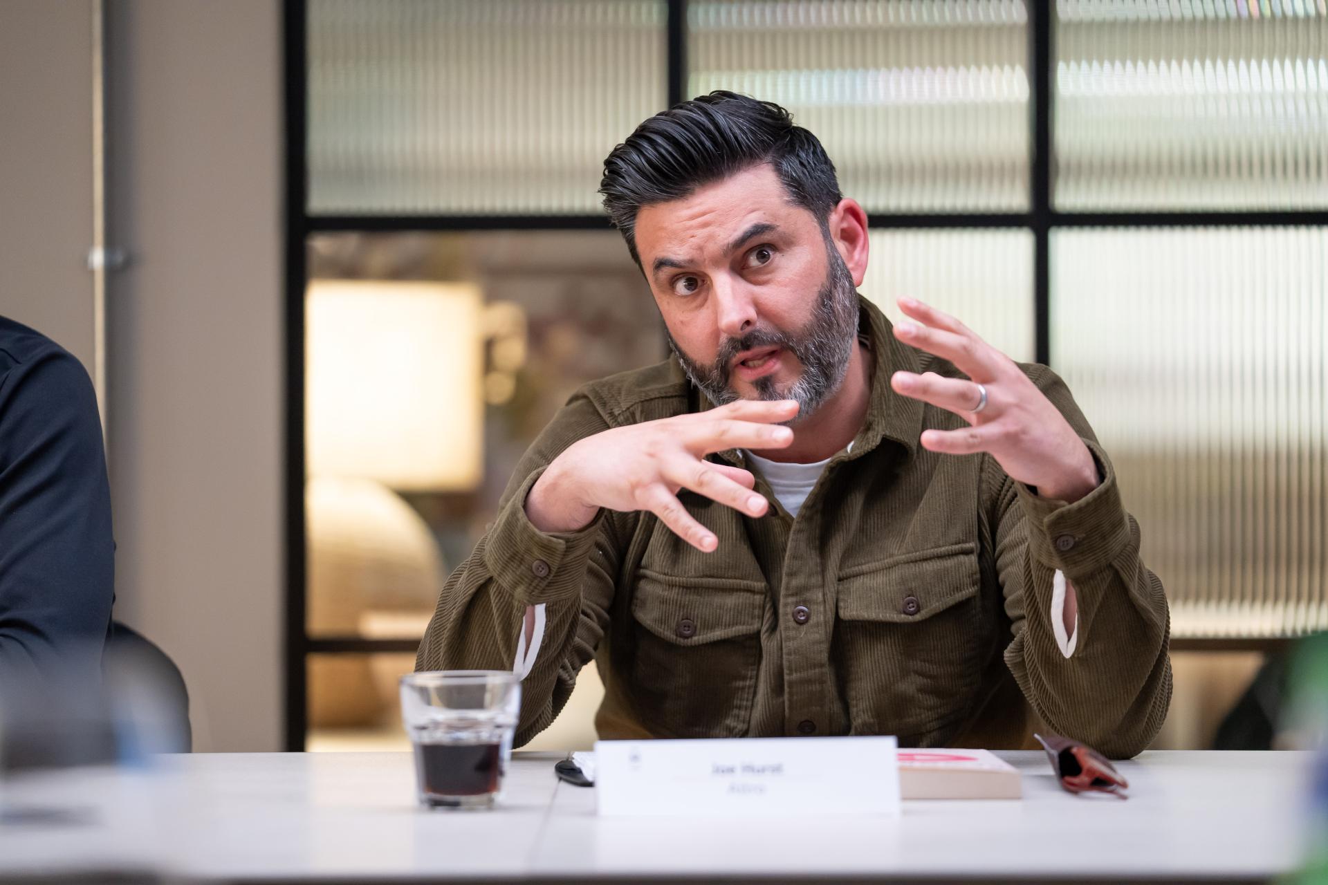 Discussion on EDI culture at Material Source Studio featuring a participant gesturing while sharing insights.