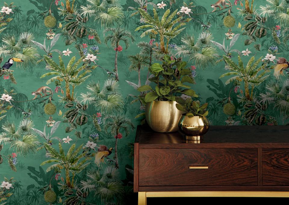 Vivid nature-inspired wallcovering featuring tropical plants and wildlife, showcased alongside a wooden table and decorative plants.