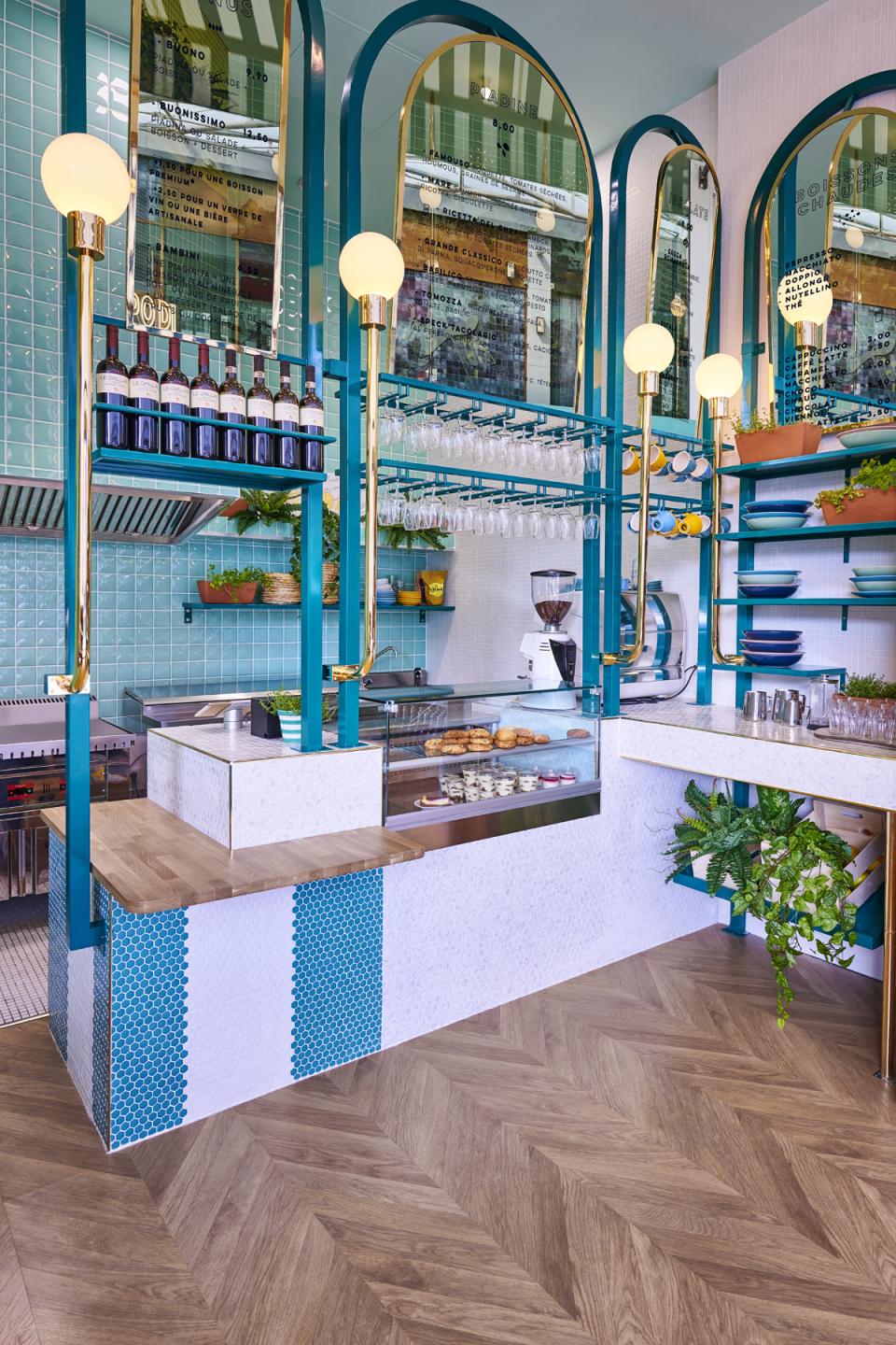 Contemporary Italian restaurant interior featuring a stylish counter, wine display, and vibrant decor by Masquespacio in Lyon.