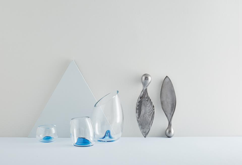 Distinctive glass and metal designs displayed in a minimalistic arrangement, showcasing innovative talent at New Designers London.