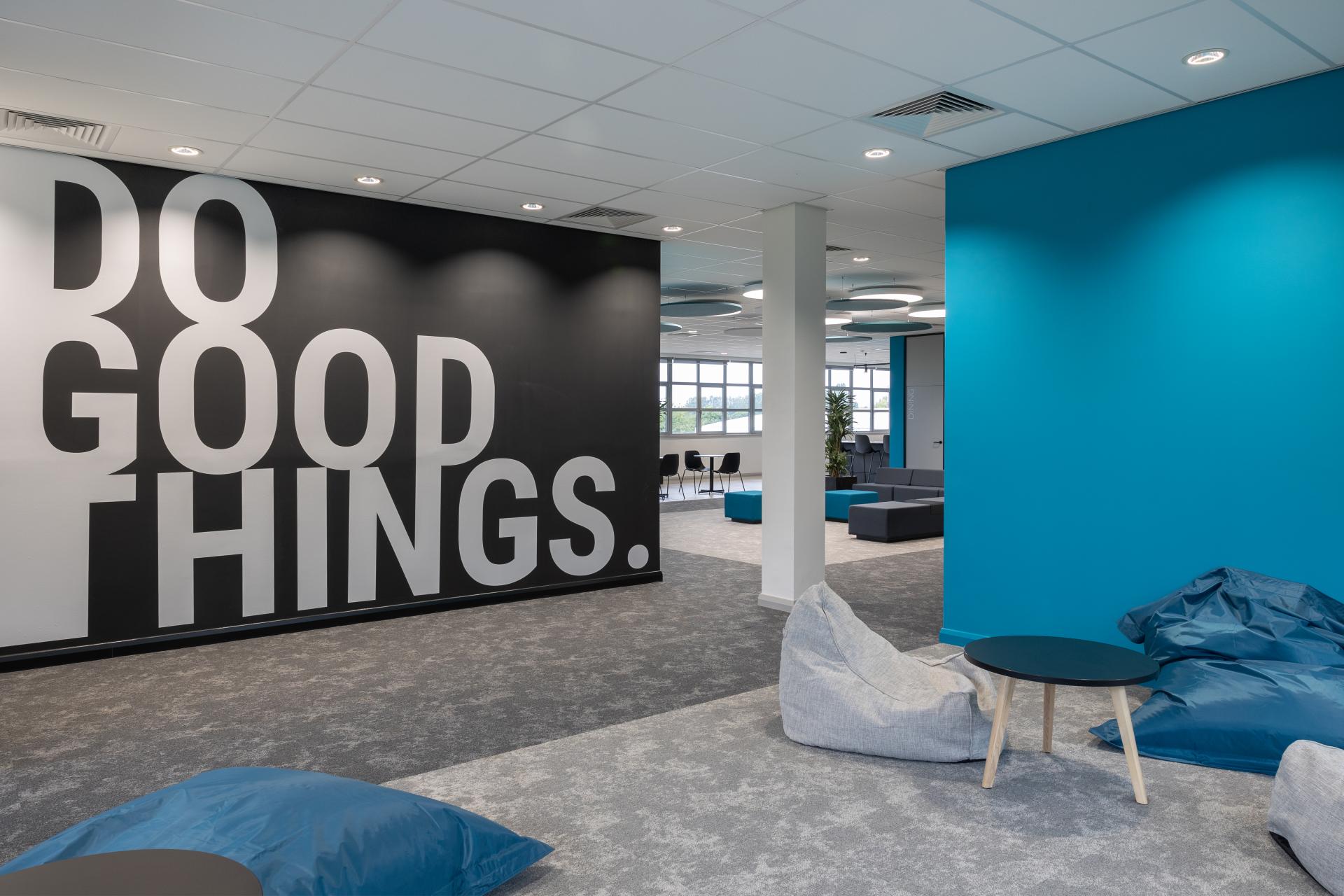 Creative workspace at M1NT Studio featuring a motivational wall and modern seating arrangements for collaborative discussions.