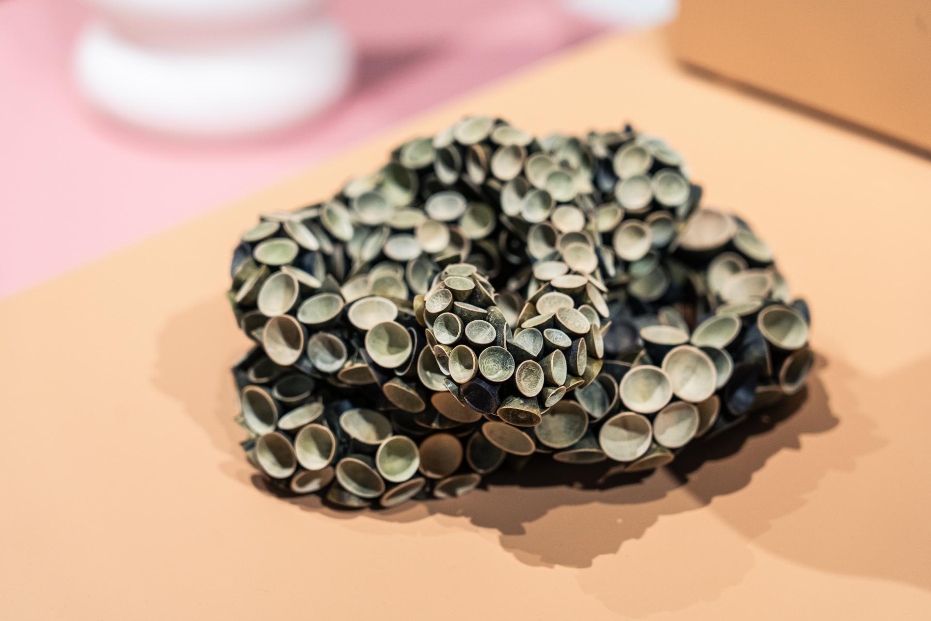 Sculptural artwork made of circular elements displayed at the Makers in Residence showcase in Glasgow, highlighting contemporary craft and design.