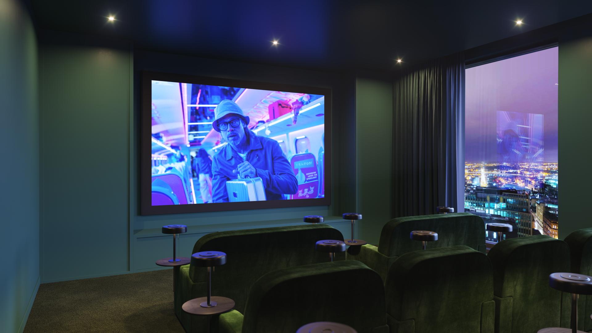 Modern cinema room in Glasgow's Moda development, featuring plush seating and a large screen displaying vibrant visuals.