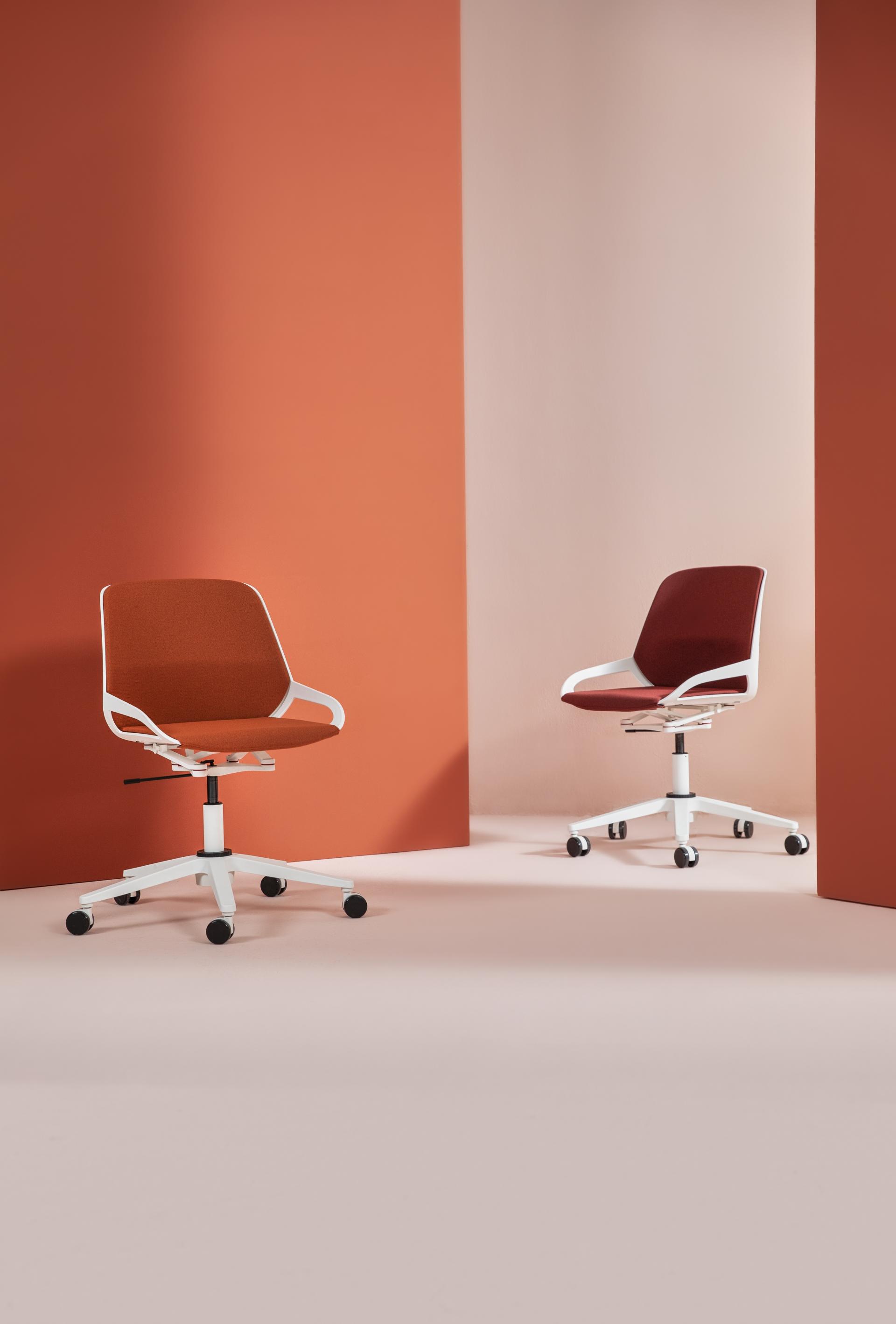 Modern office chairs in warm tones showcased against a minimalist backdrop, highlighting innovative design at Clerkenwell Design Week.