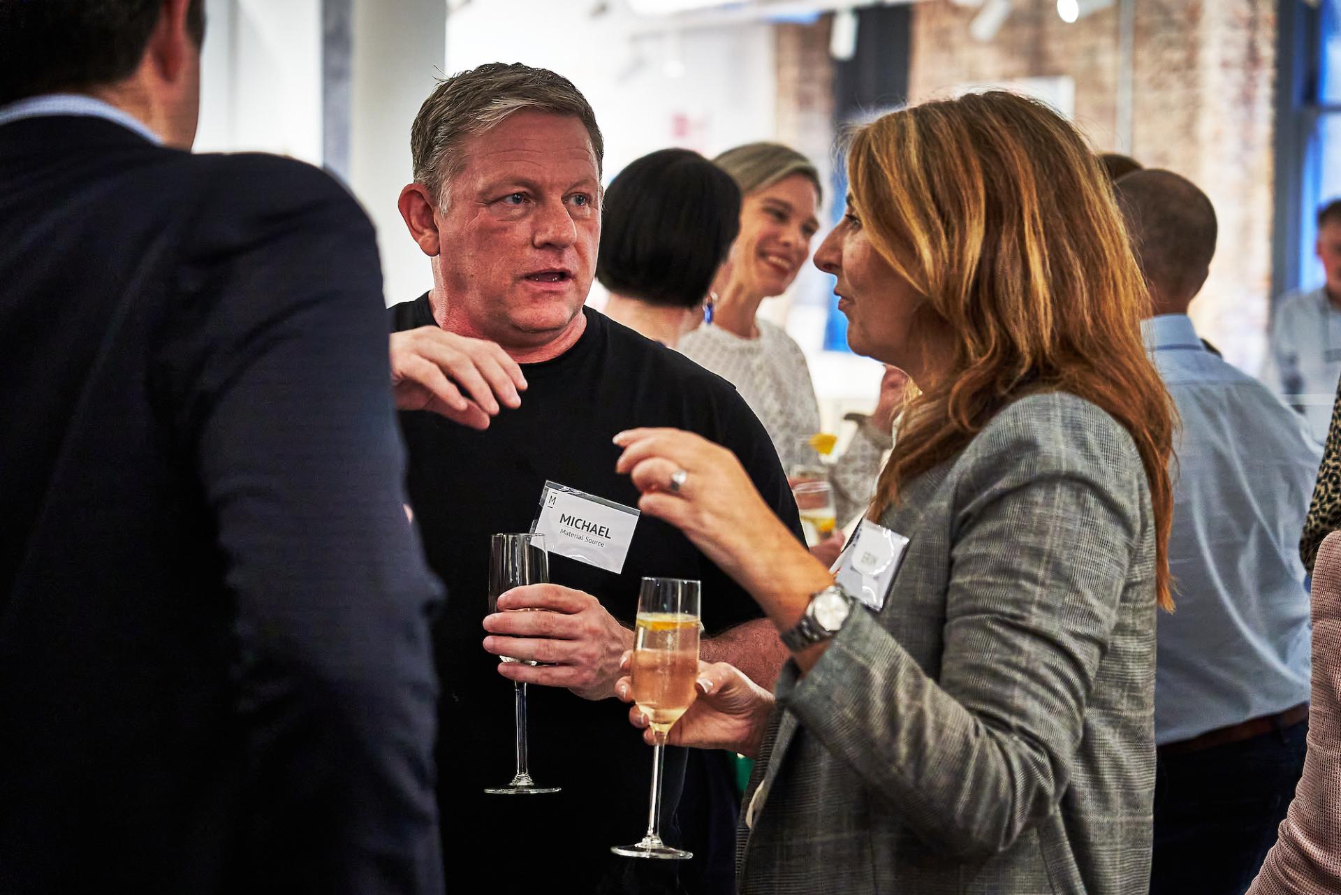 Attendees engage in conversation and celebrate at the 42 Gathering event for the podcast on built environment roles.