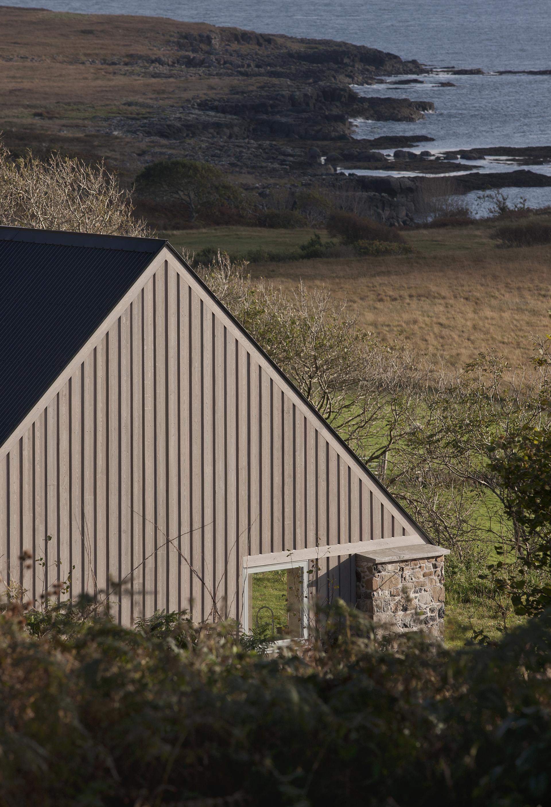 Restored croft on the Isle of Mull, showcasing modern architecture integrated with natural surroundings in a retrofit design.