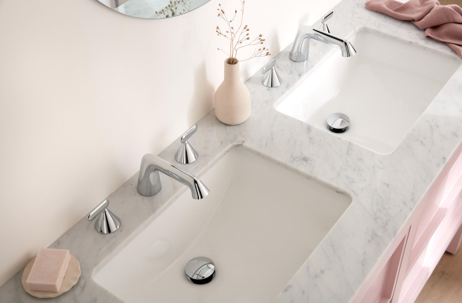 Modern bathroom sink setup featuring VADO fixtures, marble countertop, and elegant decor by Conran and Partners.