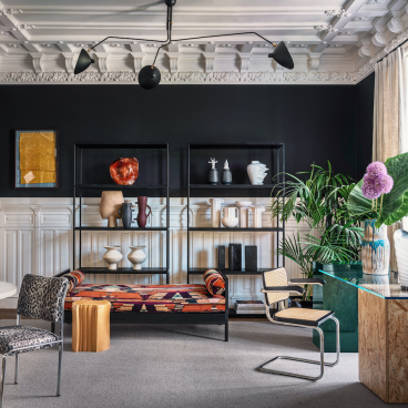 Elegant interior featuring new luxury furniture by Cristina Jorge de Carvalho, including a colorful sofa and artistic decor.