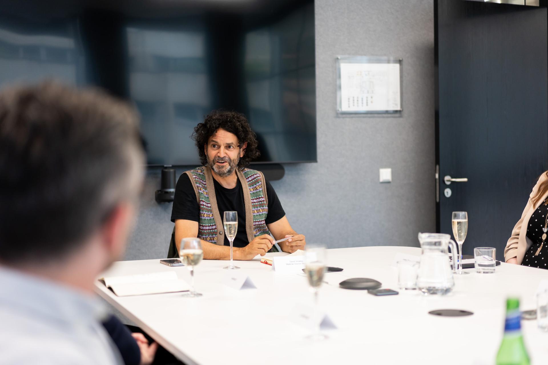 Collaborative meeting in a modern office space focused on technology and innovative workplace strategies.