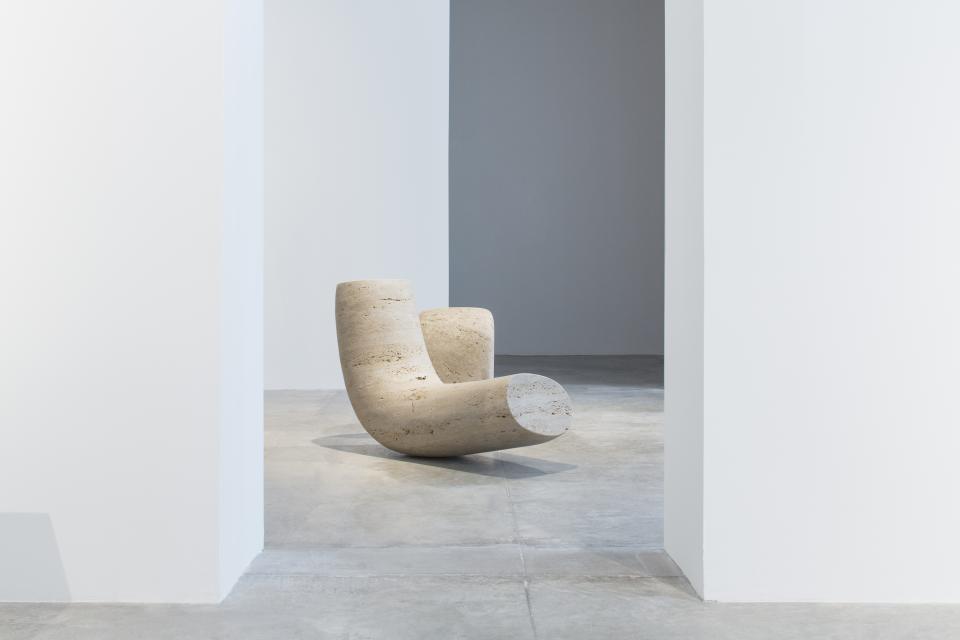 Organic sculptural chair by Wendell Castle displayed in a minimalist gallery space, highlighting the designer's innovative style.