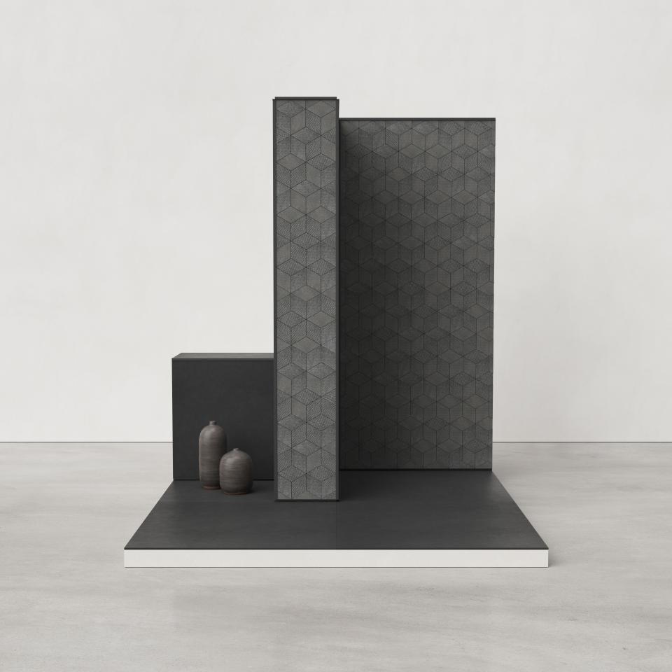 Modern interior featuring Mutina's geometric ceramic tiles in shades of gray, complemented by minimalist pottery.