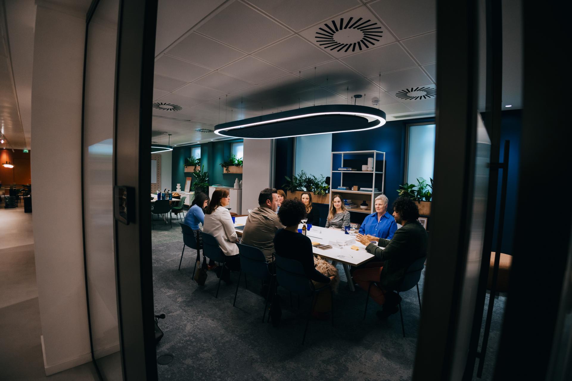 Roundtable discussion on neurodiversity at Material Source Studio, featuring diverse participants engaged in conversation.