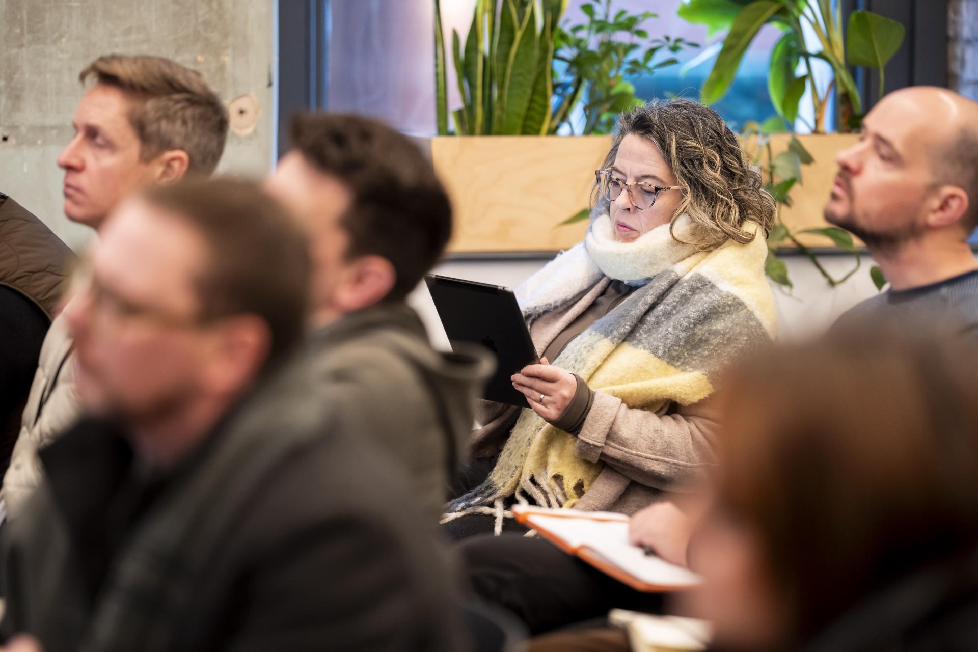 Attendees listen attentively during a discussion on graphene innovations at the Graphene Engineering Innovation Centre in Manchester.