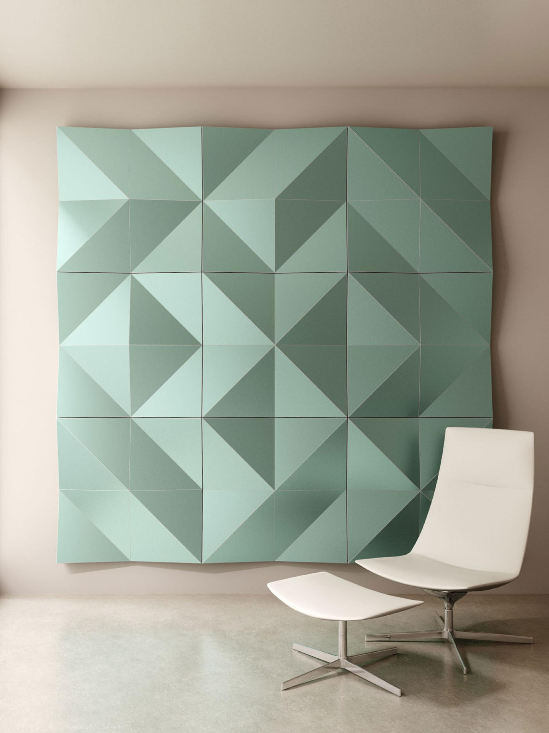 Geometric mint-green Fold Panels on a wall, accompanied by a sleek white chair and ottoman in a modern setting.